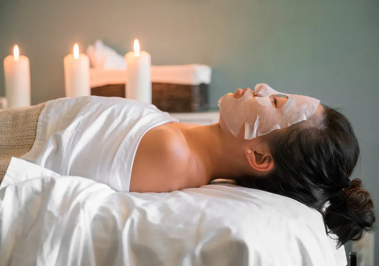 A client relaxing during a facial treatment at a spa